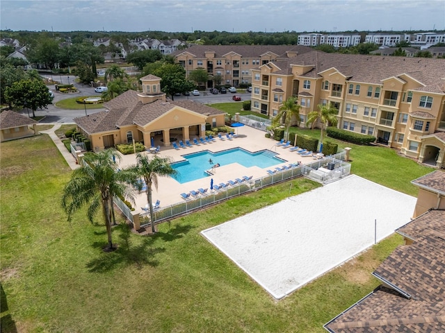 exterior space featuring a yard, fence, a residential view, and volleyball court