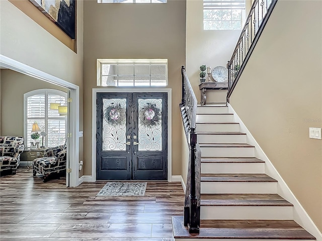3008 Sutton Woods Dr, Plant City, FL 33566 - entryway featuring a high ceiling, stairs, wood finished floors, and a wealth of natural light