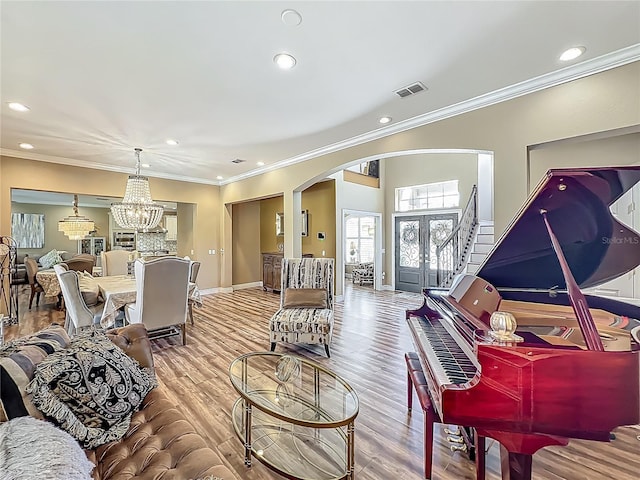 3008 Sutton Woods Dr, Plant City, FL 33566 - living room with a notable chandelier, arched walkways, recessed lighting, visible vents, and ornamental molding