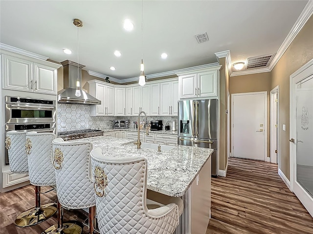 3008 Sutton Woods Dr, Plant City, FL 33566 - kitchen with crown molding, stainless steel appliances, wall chimney exhaust hood, and tasteful backsplash