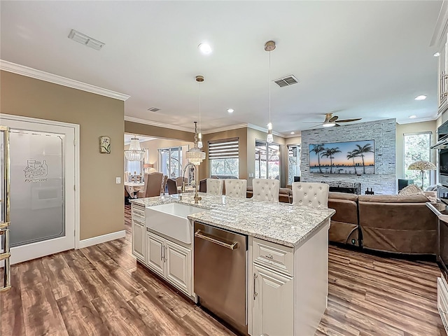 3008 Sutton Woods Dr, Plant City, FL 33566 - kitchen featuring stainless steel dishwasher, ceiling fan, visible vents, and a sink