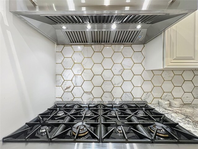 3008 Sutton Woods Dr, Plant City, FL 33566 - interior details with stovetop with downdraft, backsplash, light stone counters, and premium range hood