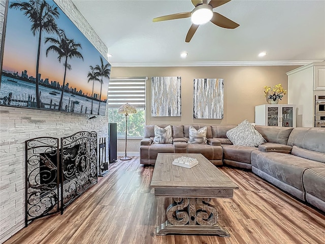 3008 Sutton Woods Dr, Plant City, FL 33566 - living room with ornamental molding, a fireplace, a ceiling fan, and wood finished floors