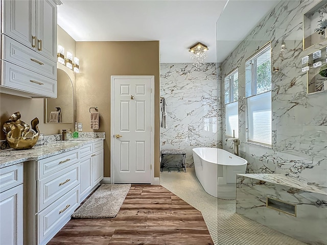 3008 Sutton Woods Dr, Plant City, FL 33566 - full bathroom featuring vanity, a freestanding tub, and wood finished floors