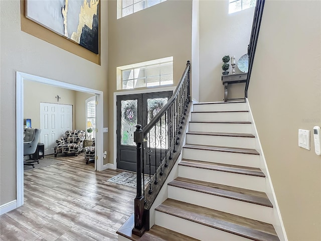3008 Sutton Woods Dr, Plant City, FL 33566 - entrance foyer featuring stairs, baseboards, wood finished floors, and a towering ceiling