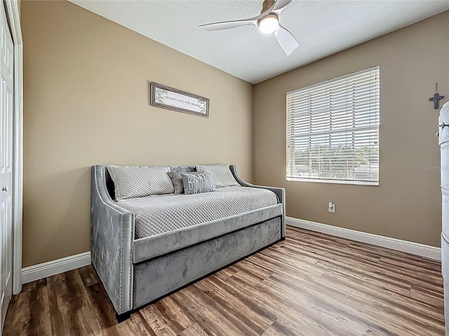 3008 Sutton Woods Dr, Plant City, FL 33566 - bedroom featuring baseboards, a ceiling fan, and wood finished floors