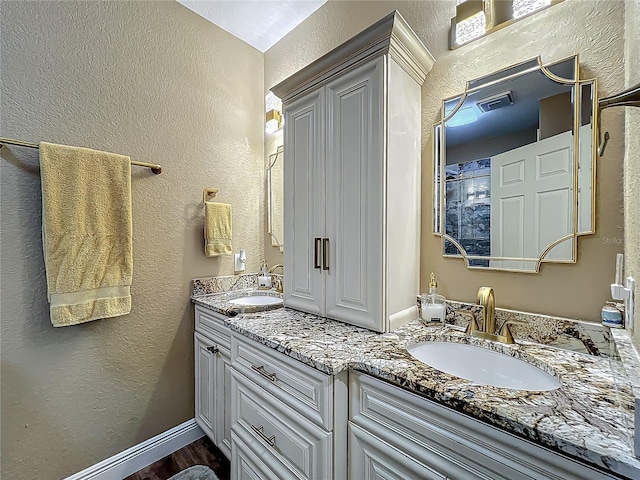 3008 Sutton Woods Dr, Plant City, FL 33566 - full bath featuring double vanity, a textured wall, and a sink