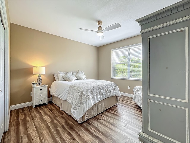 3008 Sutton Woods Dr, Plant City, FL 33566 - bedroom featuring dark wood-style flooring, baseboards, and a ceiling fan