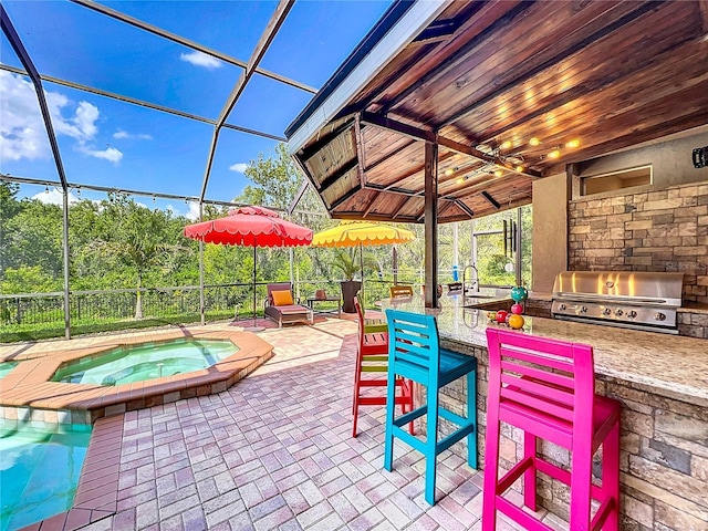 3008 Sutton Woods Dr, Plant City, FL 33566 - view of patio / terrace with area for grilling, an in ground hot tub, a lanai, a sink, and an outdoor kitchen