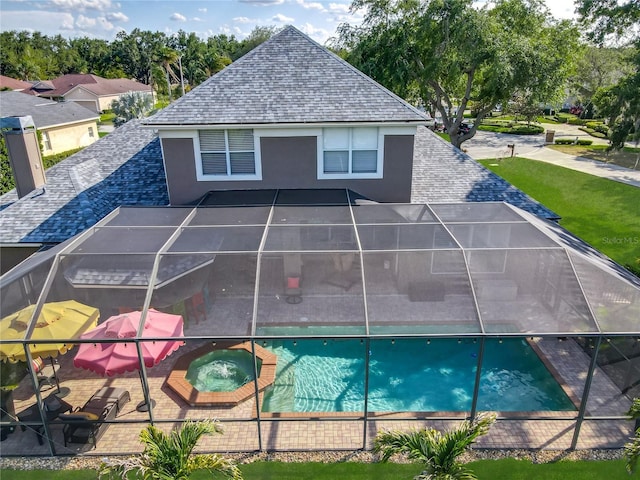3008 Sutton Woods Dr, Plant City, FL 33566 - rear view of property featuring a patio, stucco siding, a shingled roof, glass enclosure, and a pool with connected hot tub
