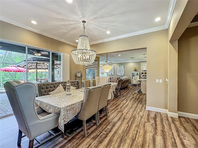 3008 Sutton Woods Dr, Plant City, FL 33566 - dining space featuring crown molding, recessed lighting, wood finished floors, and an inviting chandelier
