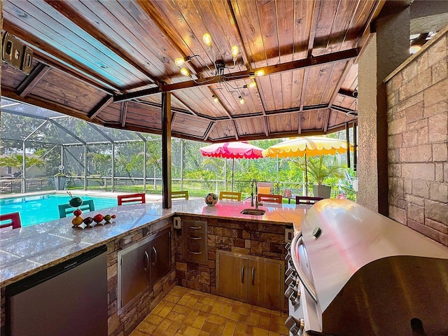 3008 Sutton Woods Dr, Plant City, FL 33566 - view of patio / terrace featuring exterior kitchen, an outdoor pool, a sink, glass enclosure, and a grill