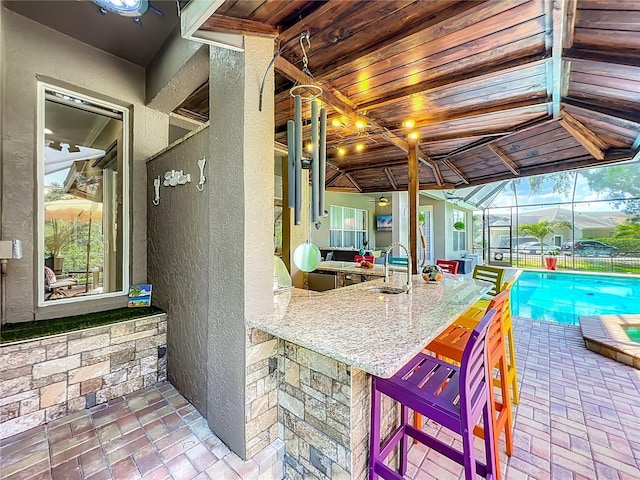 3008 Sutton Woods Dr, Plant City, FL 33566 - view of patio with a sink, a fenced in pool, a lanai, and outdoor dry bar