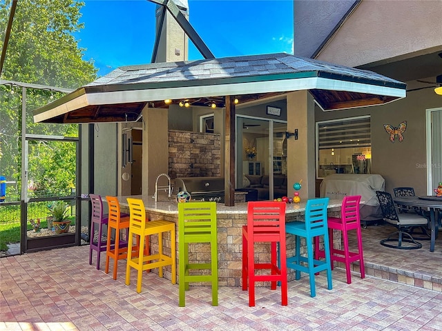3008 Sutton Woods Dr, Plant City, FL 33566 - view of patio featuring glass enclosure, grilling area, and outdoor dry bar