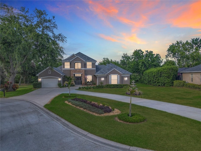 3008 Sutton Woods Dr, Plant City, FL 33566 - traditional-style home with stucco siding, concrete driveway, and a front yard