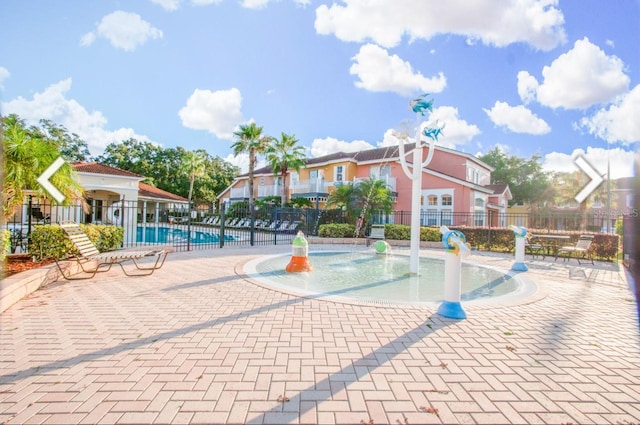 1000 Park Club Dr, Kissimmee, FL 34746 - view of community with a patio area, fence, and a swimming pool