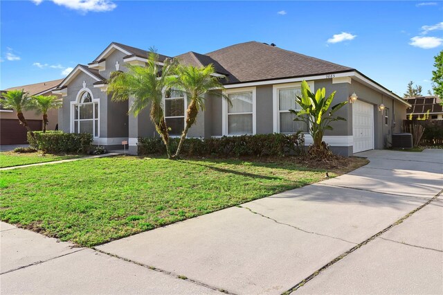 9885 Montclair Cir, Apopka, FL 32703 - ranch-style home featuring a front yard, central AC unit, a garage, concrete driveway, and stucco siding