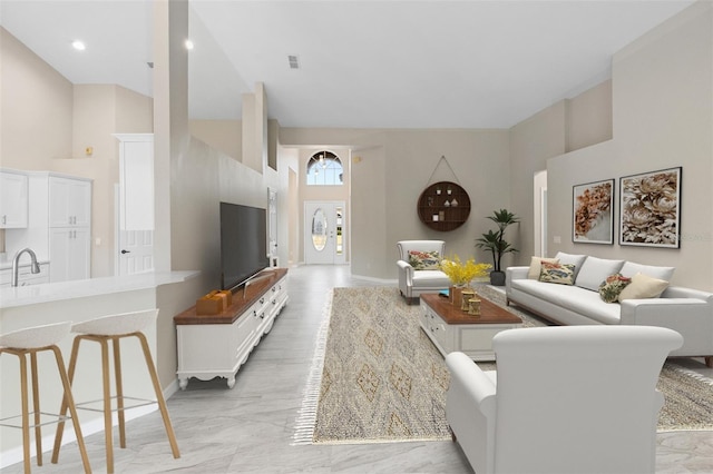 9885 Montclair Cir, Apopka, FL 32703 - living room with high vaulted ceiling, baseboards, visible vents, and marble finish floor
