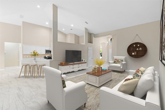 9885 Montclair Cir, Apopka, FL 32703 - living area featuring baseboards, marble finish floor, visible vents, and high vaulted ceiling