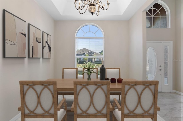 9885 Montclair Cir, Apopka, FL 32703 - dining area with a tray ceiling, an inviting chandelier, and marble finish floor