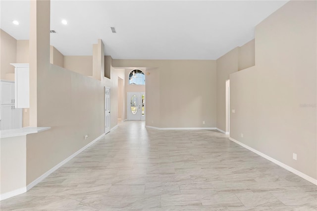 9885 Montclair Cir, Apopka, FL 32703 - spare room with baseboards, visible vents, marble finish floor, and a towering ceiling