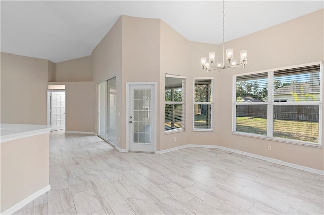 9885 Montclair Cir, Apopka, FL 32703 - spare room featuring baseboards, a notable chandelier, and high vaulted ceiling