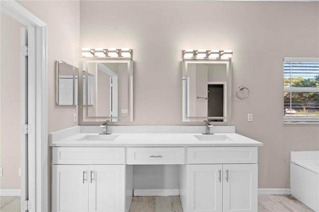 9885 Montclair Cir, Apopka, FL 32703 - full bath featuring double vanity, a sink, baseboards, and a tub to relax in
