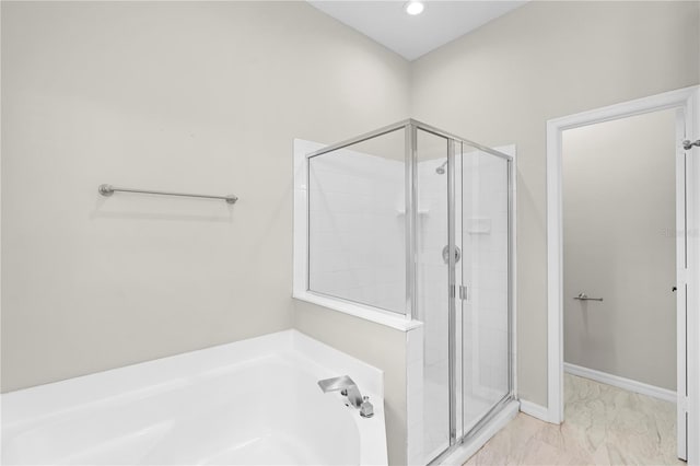 9885 Montclair Cir, Apopka, FL 32703 - full bathroom featuring marble finish floor, recessed lighting, a shower stall, and a garden tub
