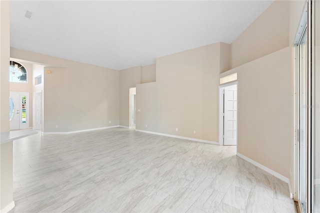 9885 Montclair Cir, Apopka, FL 32703 - unfurnished room with baseboards, a high ceiling, marble finish floor, and visible vents