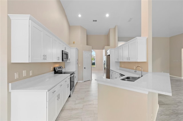9885 Montclair Cir, Apopka, FL 32703 - kitchen featuring a sink, light countertops, high vaulted ceiling, stainless steel appliances, and a peninsula