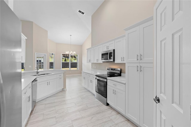 9885 Montclair Cir, Apopka, FL 32703 - kitchen with an inviting chandelier, a sink, light countertops, stainless steel appliances, and visible vents