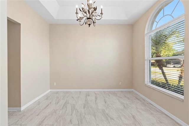 9885 Montclair Cir, Apopka, FL 32703 - unfurnished room with an inviting chandelier, baseboards, a tray ceiling, and marble finish floor