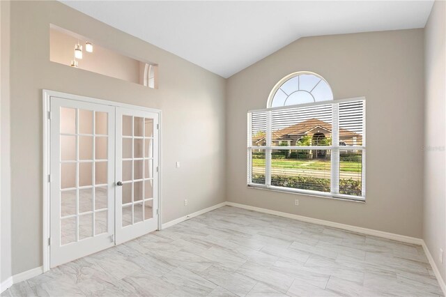 9885 Montclair Cir, Apopka, FL 32703 - empty room with vaulted ceiling, baseboards, and french doors