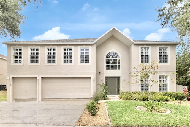 2658 Palmetto Ridge Cir, Apopka, FL 32712 - view of front of property with an attached garage, driveway, stucco siding, a front lawn, and cooling unit