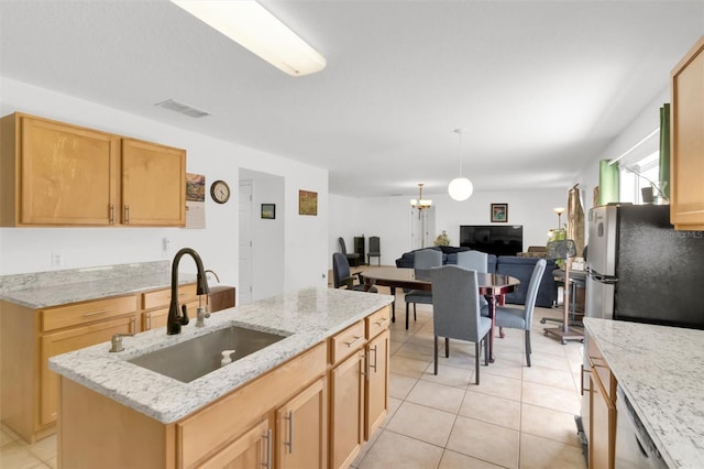 2658 Palmetto Ridge Cir, Apopka, FL 32712 - kitchen featuring a sink, light tile patterned floors, freestanding refrigerator, light stone countertops, and hanging light fixtures