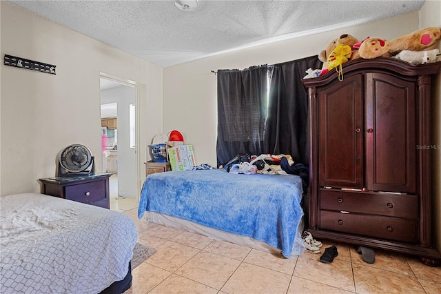 1828 Matterhorn Dr, Orlando, FL 32818 - bedroom featuring a textured ceiling and light tile patterned floors