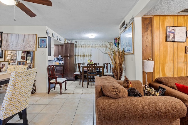 1828 Matterhorn Dr, Orlando, FL 32818 - living area featuring light tile patterned floors, a ceiling fan, a textured ceiling, and visible vents