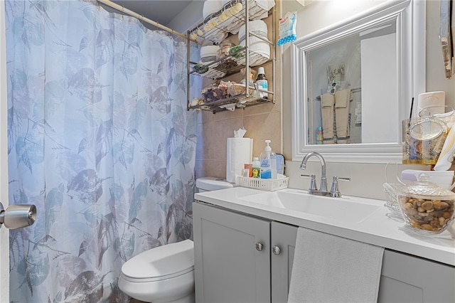 1828 Matterhorn Dr, Orlando, FL 32818 - bathroom with vanity, a shower with shower curtain, toilet, and tile walls