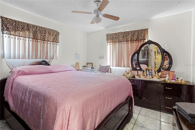1828 Matterhorn Dr, Orlando, FL 32818 - bedroom featuring a ceiling fan, a textured ceiling, and marble finish floor