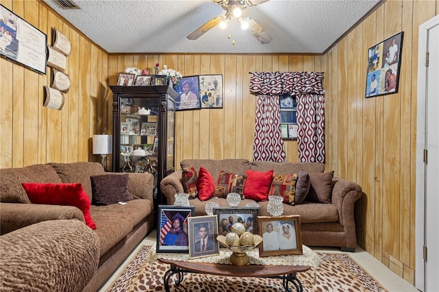 1828 Matterhorn Dr, Orlando, FL 32818 - carpeted living room featuring visible vents, wood walls, a textured ceiling, and a ceiling fan