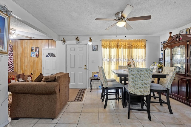 1828 Matterhorn Dr, Orlando, FL 32818 - dining space with wooden walls, a textured ceiling, ceiling fan, and light tile patterned flooring