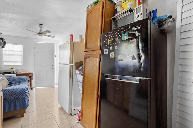 1828 Matterhorn Dr, Orlando, FL 32818 - kitchen with freestanding refrigerator, ceiling fan, brown cabinetry, and light tile patterned floors