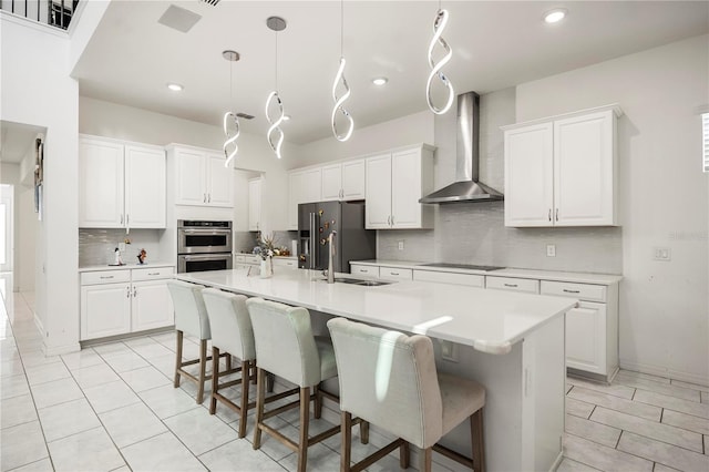 9567 Meadow Hunt Way, Winter Garden, FL 34787 - kitchen with white cabinets, high end fridge, a sink, black electric cooktop, and wall chimney exhaust hood