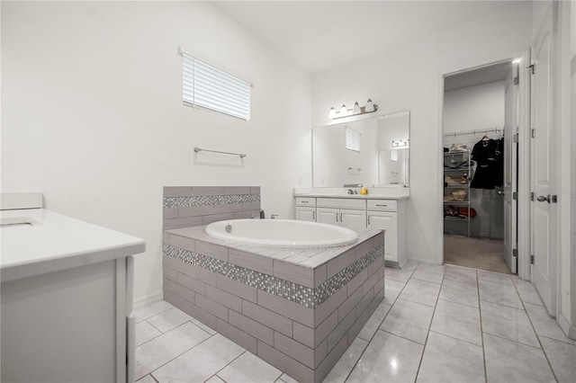9567 Meadow Hunt Way, Winter Garden, FL 34787 - bathroom featuring vanity, tile patterned flooring, a bath, and a walk in closet