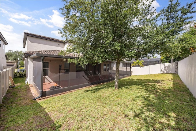 9567 Meadow Hunt Way, Winter Garden, FL 34787 - back of property featuring a sunroom, a fenced backyard, a yard, and a tile roof