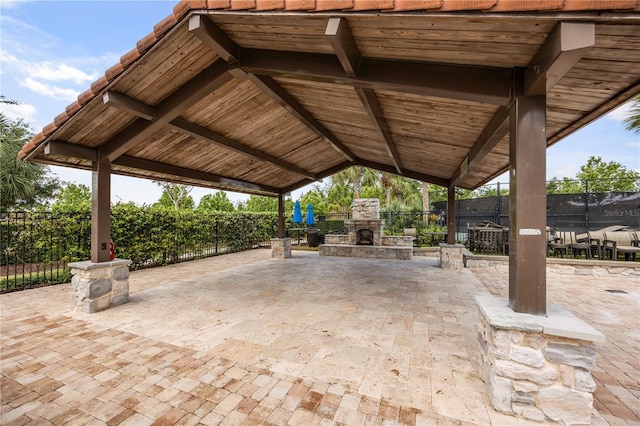 9567 Meadow Hunt Way, Winter Garden, FL 34787 - view of patio / terrace featuring fence and an outdoor stone fireplace
