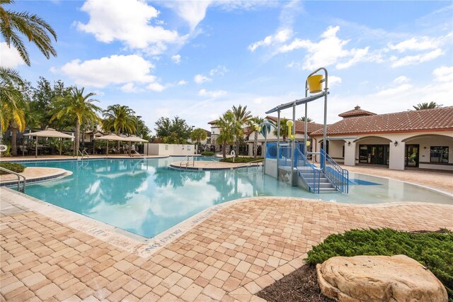 9567 Meadow Hunt Way, Winter Garden, FL 34787 - pool with a patio, a water slide, and a water play area