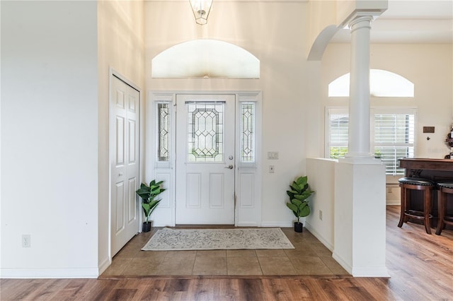 27127 Stoney Brook Dr, Leesburg, FL 34748 - tiled foyer entrance featuring ornate columns, a high ceiling, and arched walkways