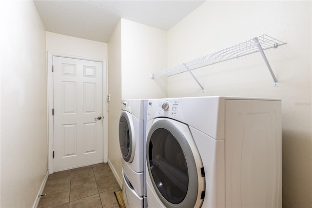 27127 Stoney Brook Dr, Leesburg, FL 34748 - washroom with washing machine and clothes dryer, baseboards, and tile patterned floors