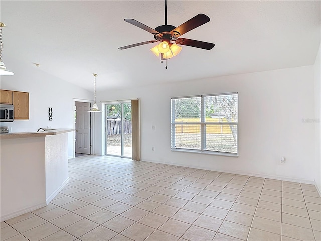 unfurnished living room featuring light tile patterned floors, lofted ceiling, and ceiling fan